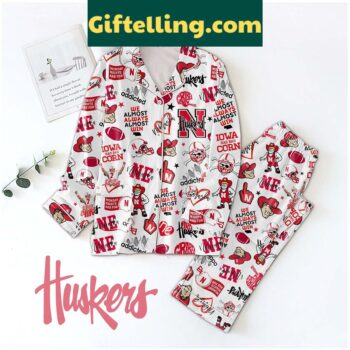 Nebraska Cornhuskers NCAA We Almost Always Almost Win Pajamas Set laid out on a bed