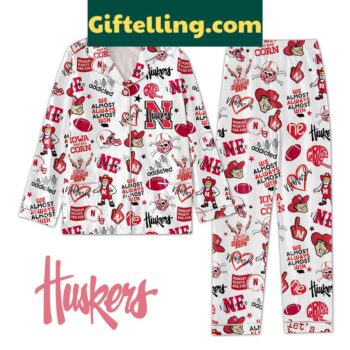 Nebraska Cornhuskers NCAA We Almost Always Almost Win Pajamas Set laid out on a bed